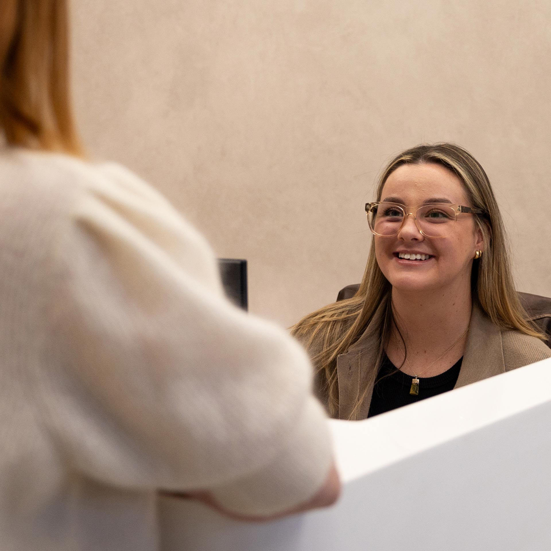 Mindplace staff member assisting a visitor at the front desk